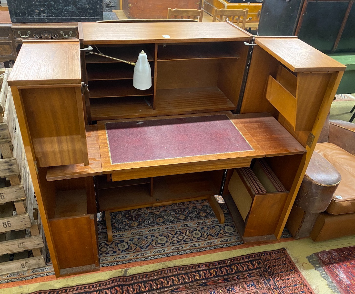 A mid century teak “Magic Box” enclosed desk possibly by Mummenthaler & Meier, Switzerland, interior with pull out drop flap writing surface, dimensions closed width 84cm, depth 54cm, height 112cm